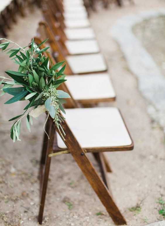 Folded chair paired with comfy cushion and greenery