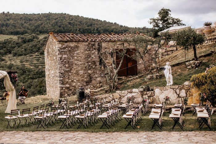 Stunning Tuscan wedding with slotted ceremony chairs